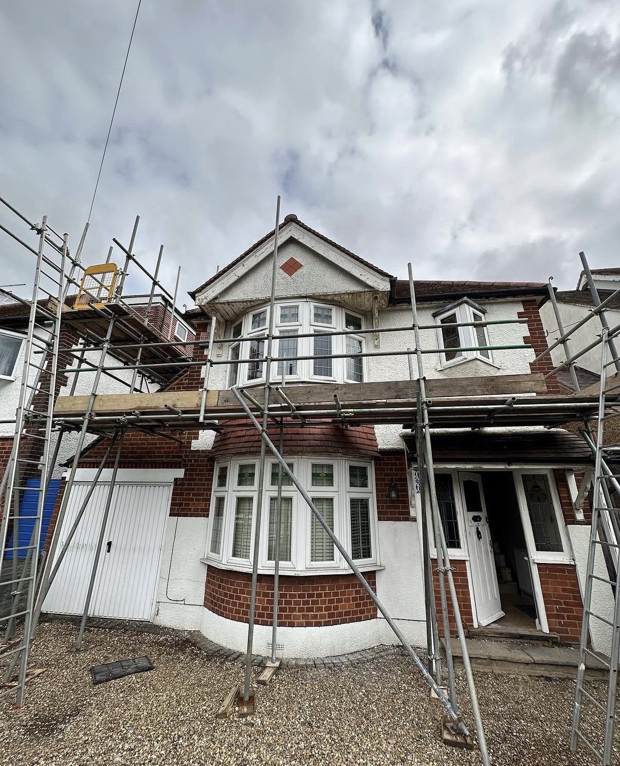 House under renovation with scaffolding outside.