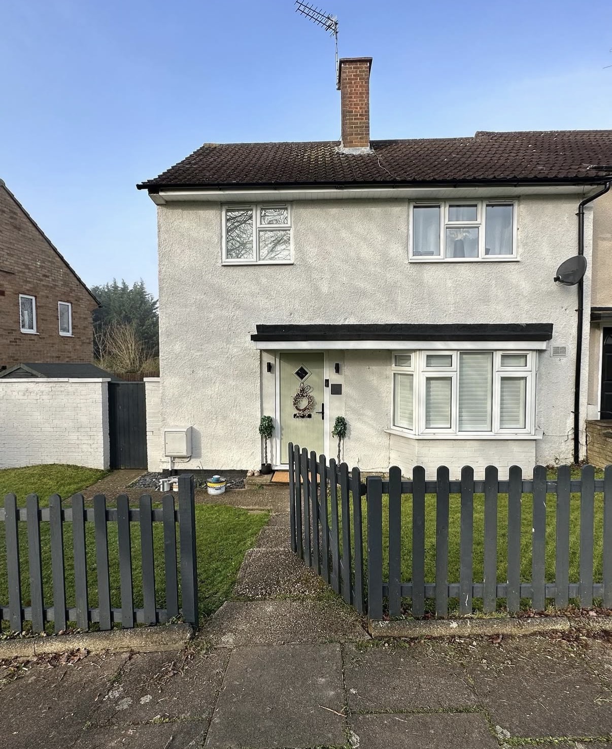 Two-story house with front yard and fence.