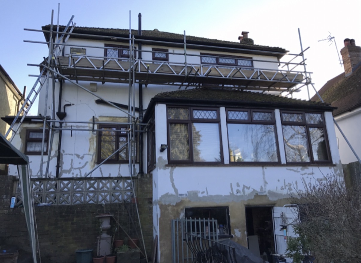 House under renovation with scaffolding outside.