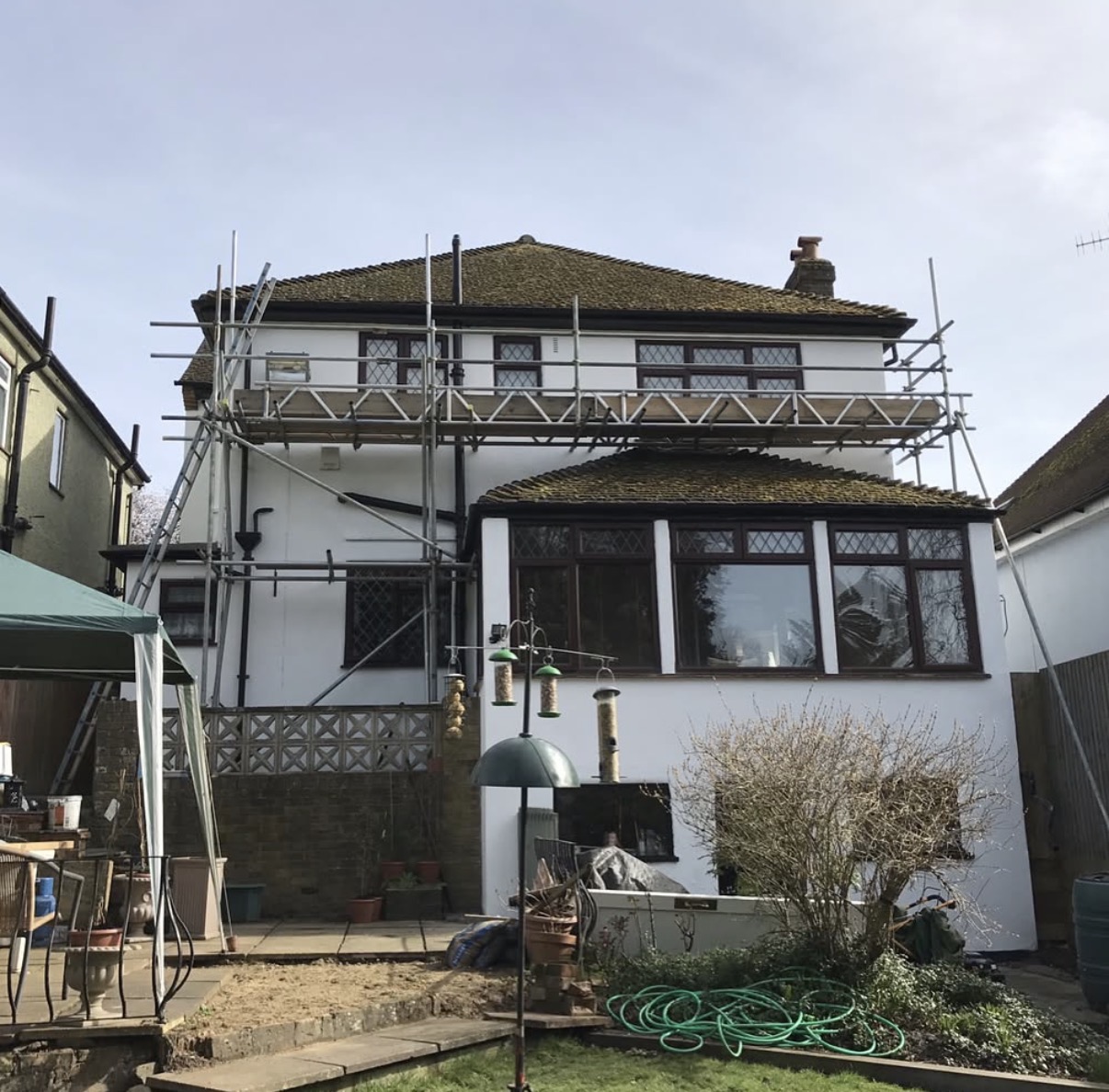 House under renovation with scaffolding outside.